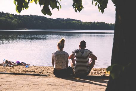 Couple talking on lake