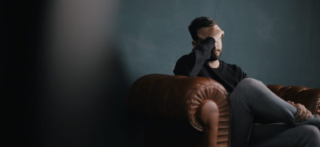 Man on couch thinking